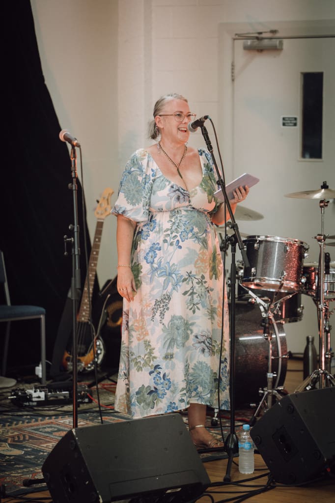 Wedding MC Auckland guiding reception with microphone, ensuring smooth flow and guest engagement
